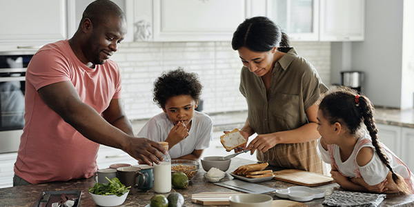 black family making lunch in the kitchen