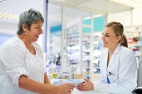woman discussing a prescription with a young female pharmacist