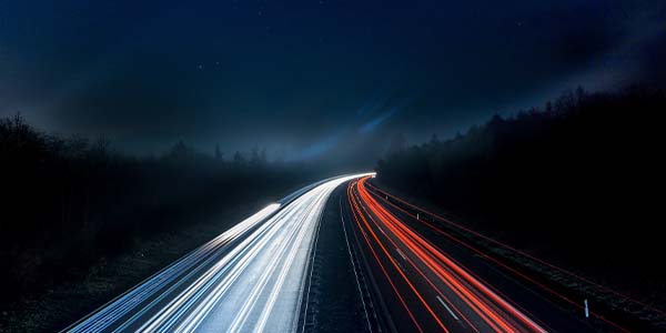 blurred traffic lights at night on highway