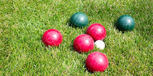 bocce balls laying in green grass