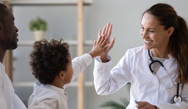 child high fiving doctor
