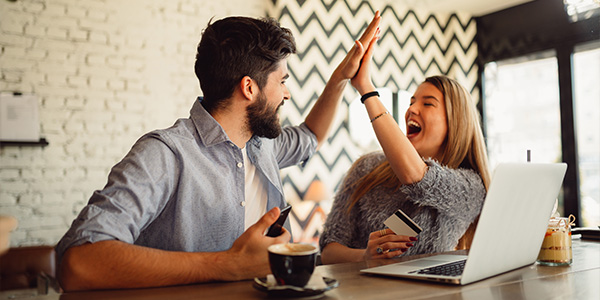 couple high fiving about finances