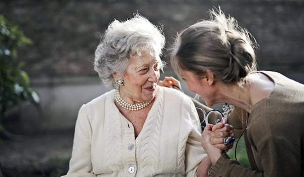 elderly woman chatting with young woman