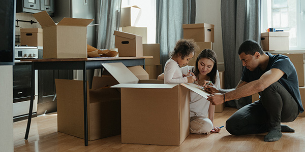 family packing boxes in living room