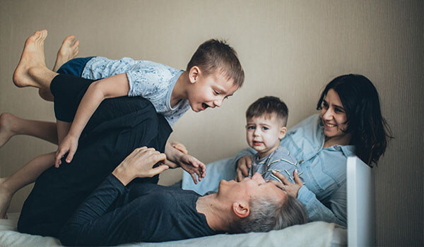 family playing on the bed
