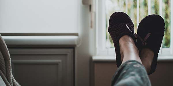 feet kicked up on couch with slippers