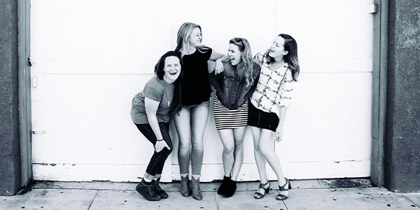 four girls laughing together