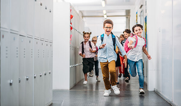 happy kids down school hallway