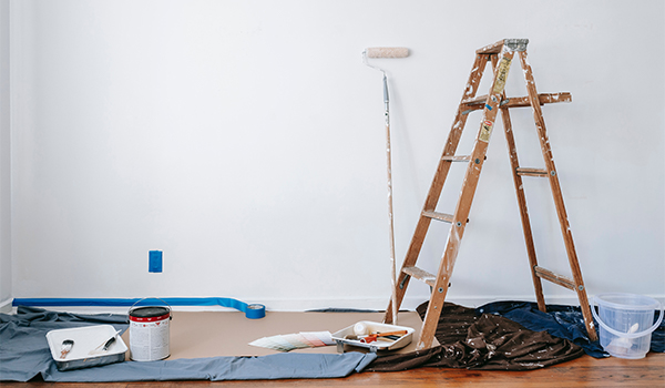 paint, dropcloth and ladder in a room