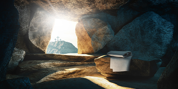 inside empty tomb with three crosses in doorway