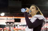 Woman drinking water during workout