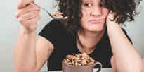 girl eating chocolate chips in a mug 