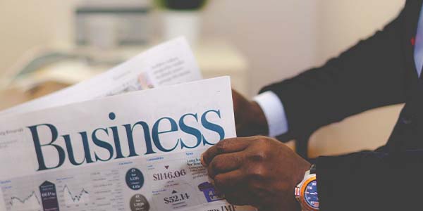 man in suit reading Business newspaper