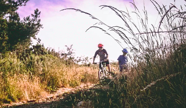mountain biking with grass in foreground