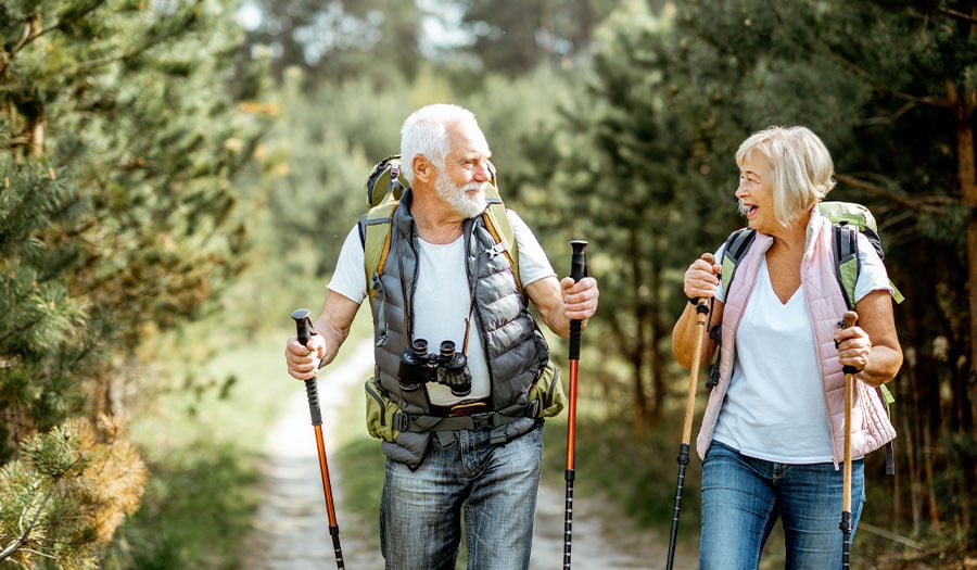 older couple hiking in woods