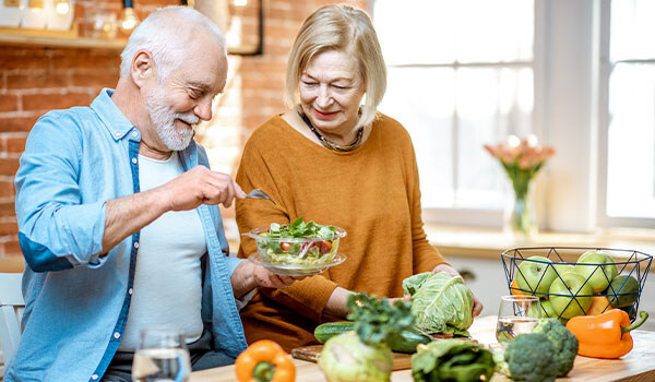older couple making a salad -1