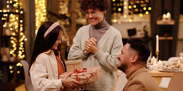 parents giving gift to child