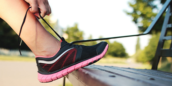 person tying running shoes