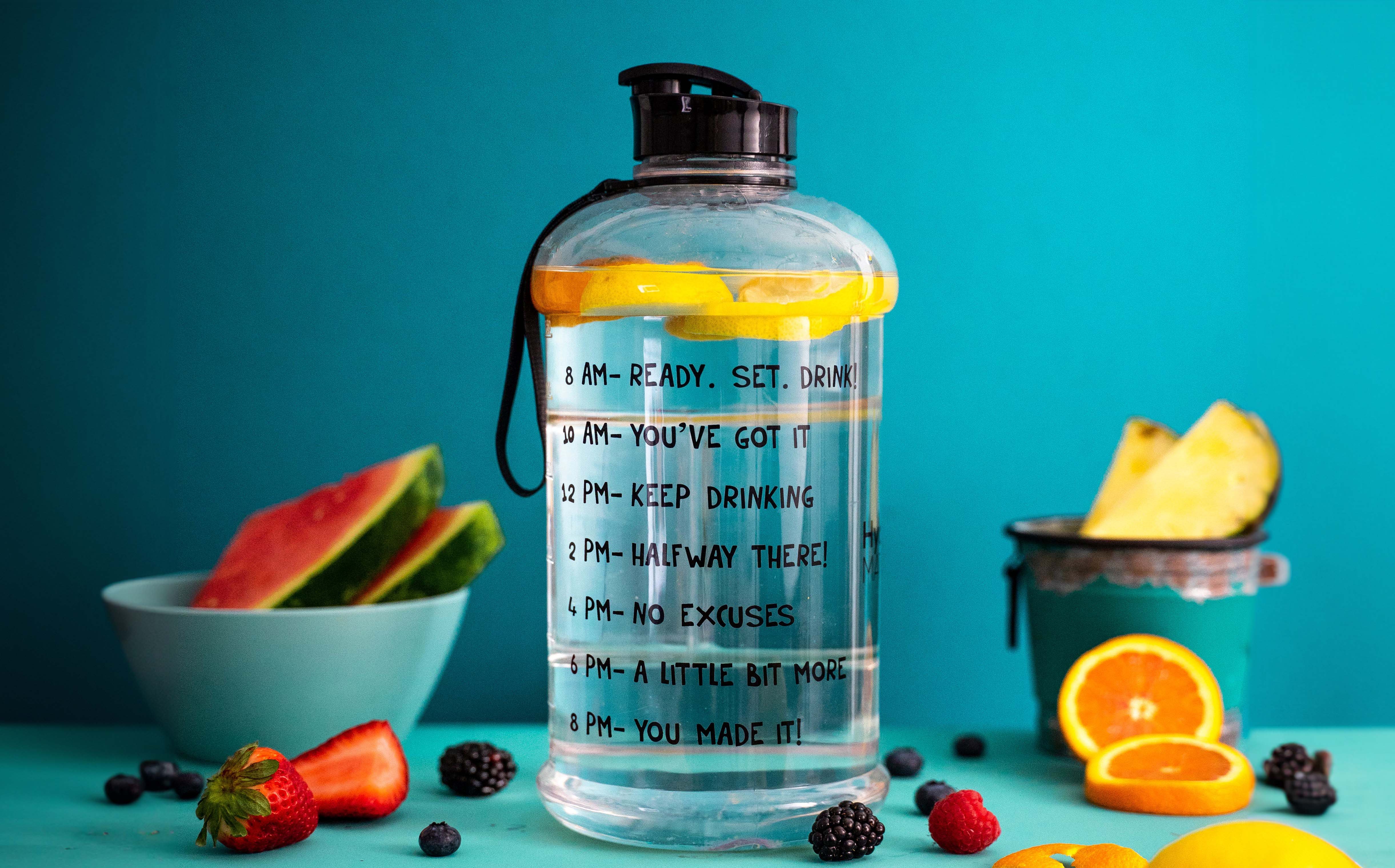 Jug of fruit-infused water with drinking goals written on the bottle