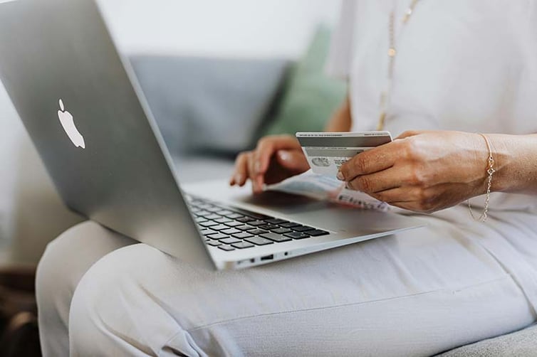 Woman typing in credit card information