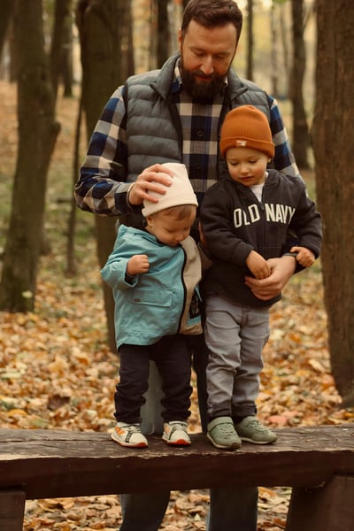Dad with two sons, hugging