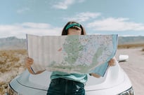 Woman looking at map. Photo by Leah Kelley: https://www.pexels.com/photo/woman-looking-at-the-map-3935702/