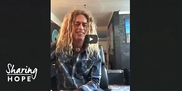 Phil Joel speaking to the camera in a Sharing Hope video, with the series logo in the corner