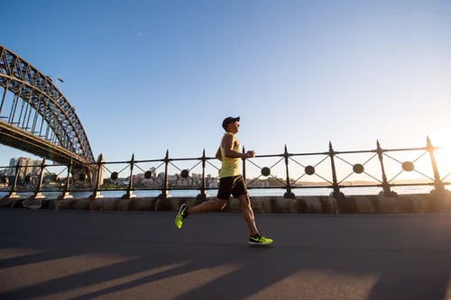 Man running across a bridge