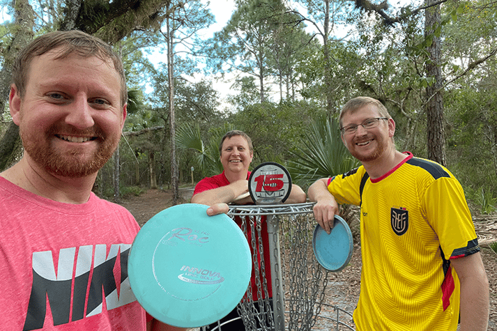 Friends playing disc golf