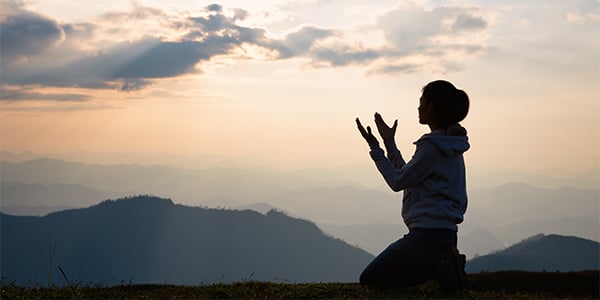 woman praying silhouette