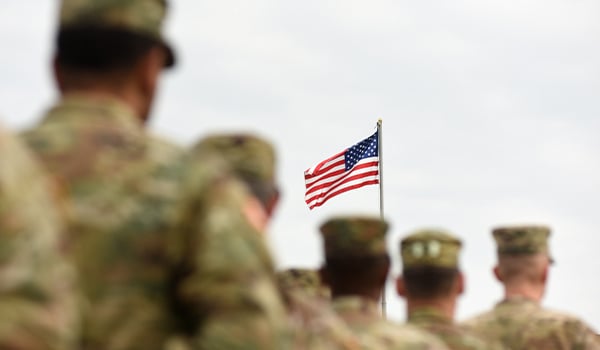 soldiers facing americna flag