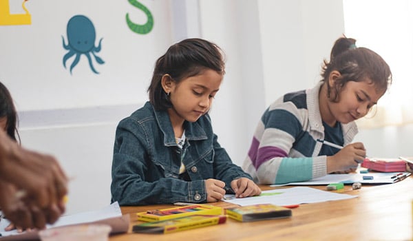 two girls doing school work