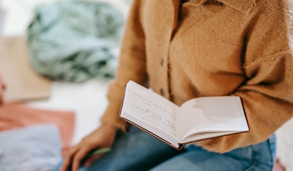 woman holding a journal