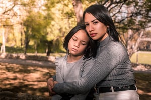 Hispanic woman comforting her daughter