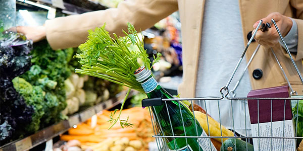 women holding basket at grocery store