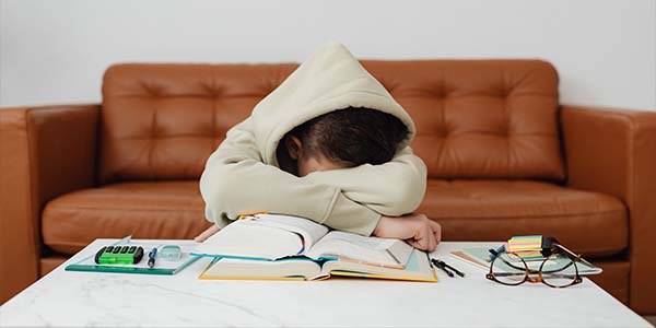 young man tired with head on table