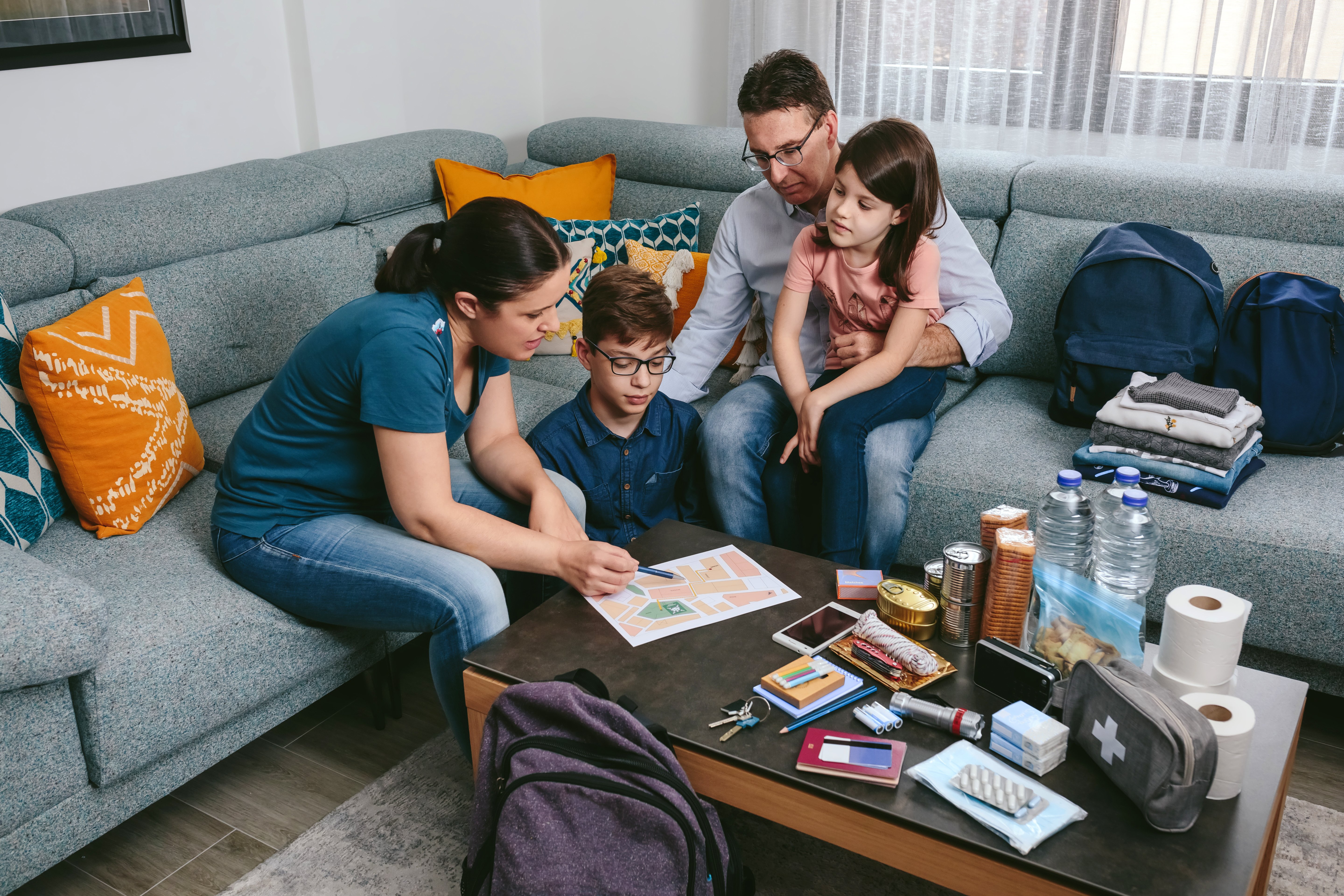a family preparing for an emergency and their supplies
