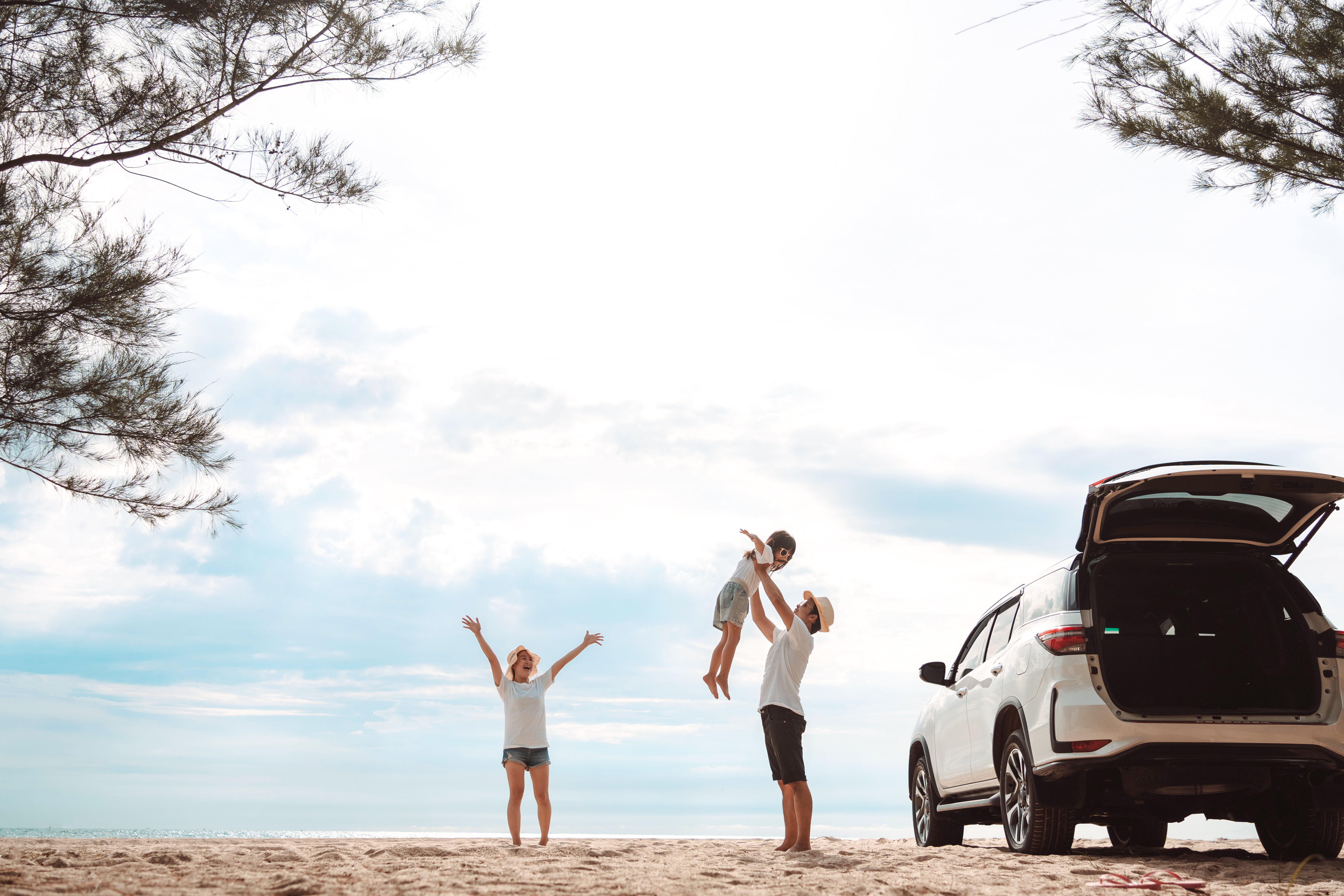 Family at beach, unpacking their SUV