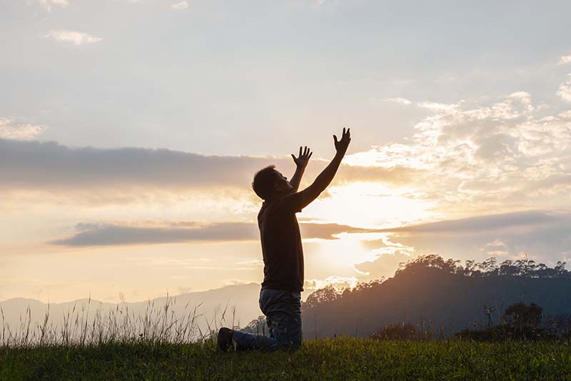 Man raising hands in prayer