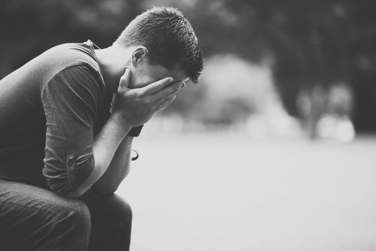 Man holding his head in his hands