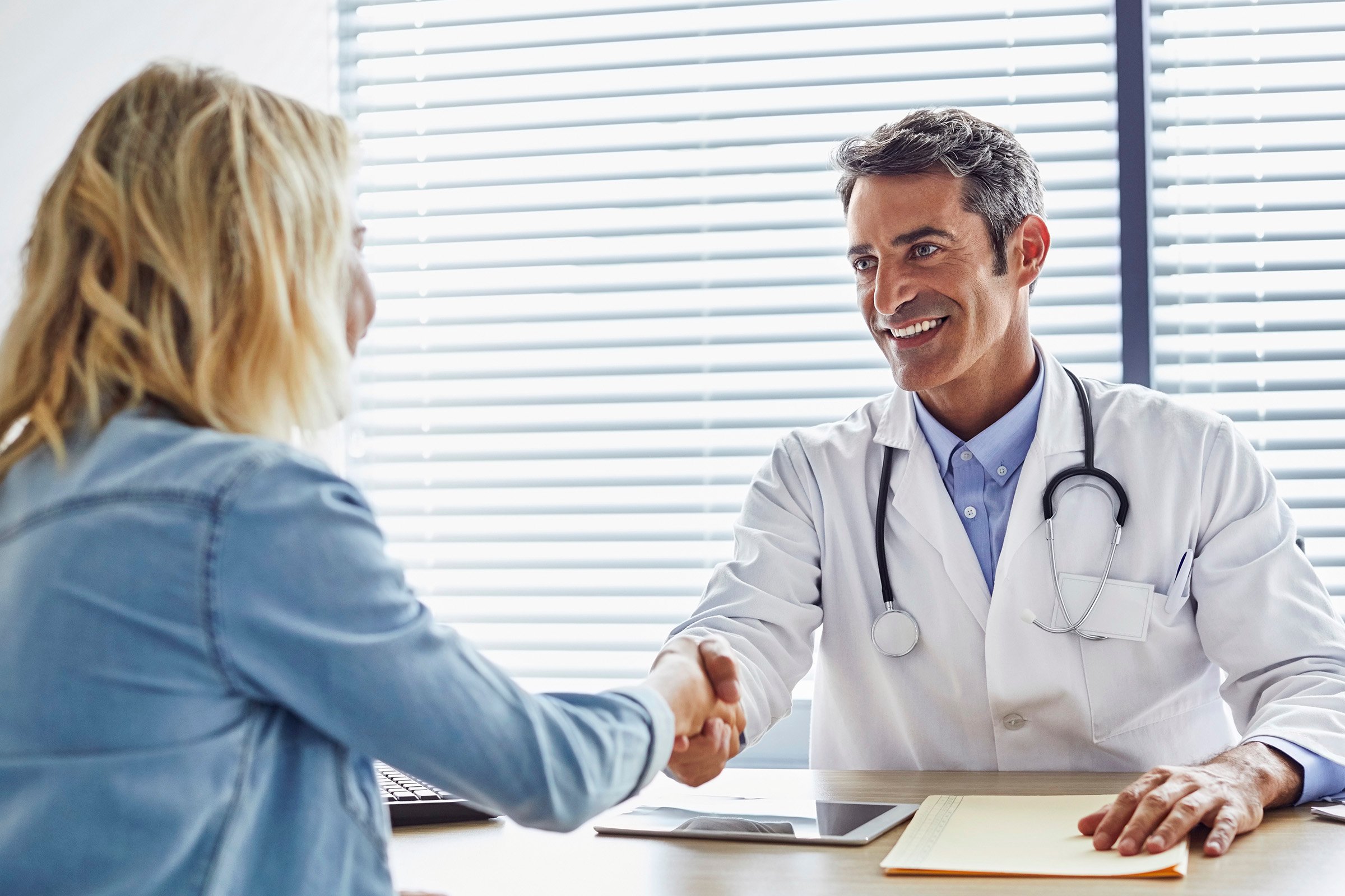 A doctor shaking his patients hand